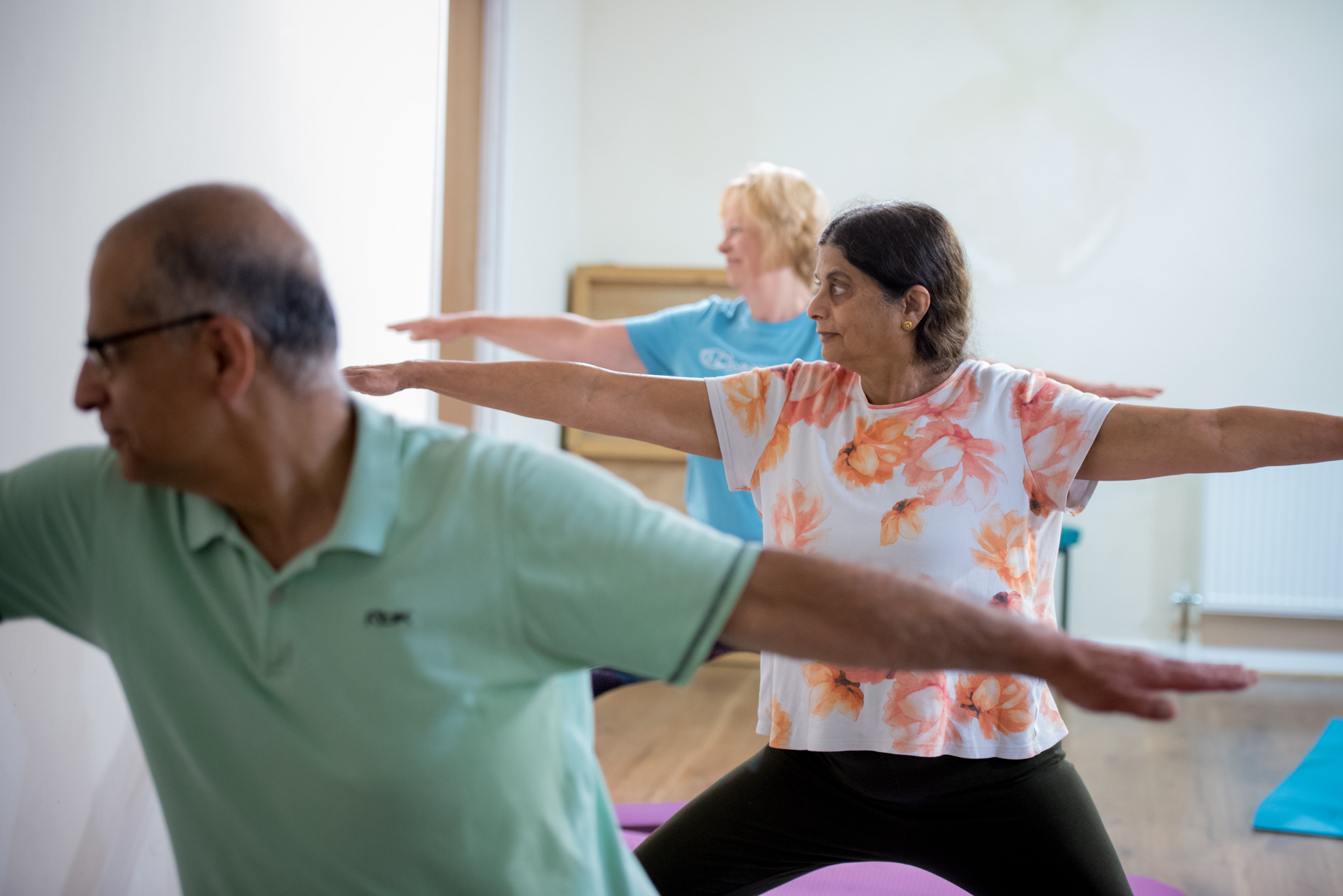 Three people in yoga pose